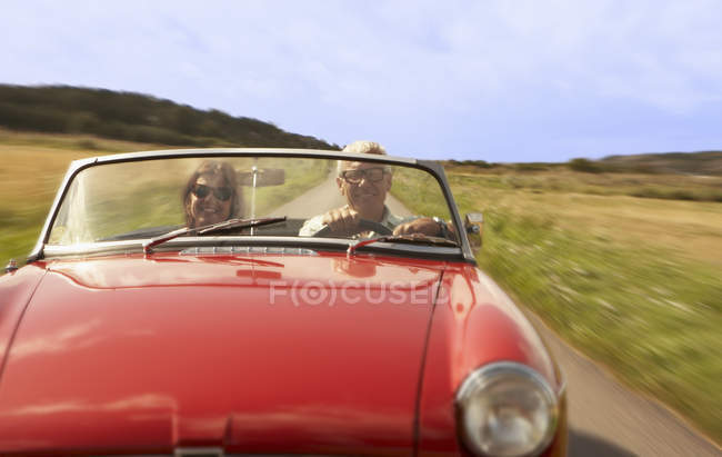 Mid aged couple in sports car — Stock Photo