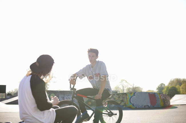 Deux jeunes hommes sur des vélos bmx au skatepark — Photo de stock