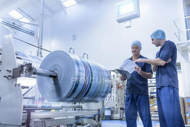 Workers in discussion in food packaging printing factory — Stock Photo