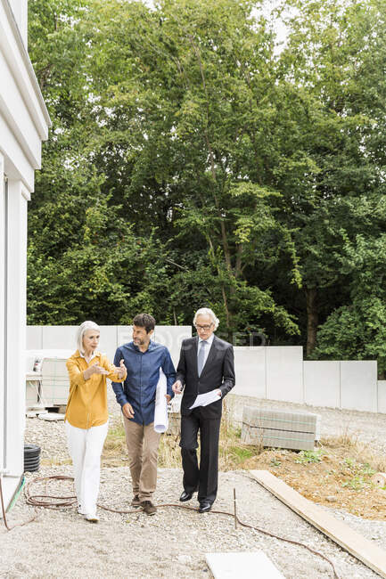 Vue frontale complète du couple discutant du réaménagement du logement avec l'architecte — Photo de stock