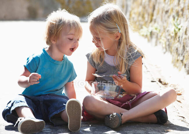 Brother and sister having a snack — Stock Photo