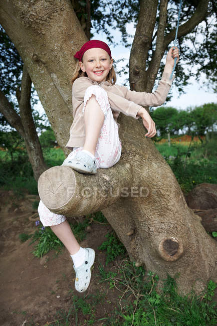Giovane ragazza su albero — Foto stock