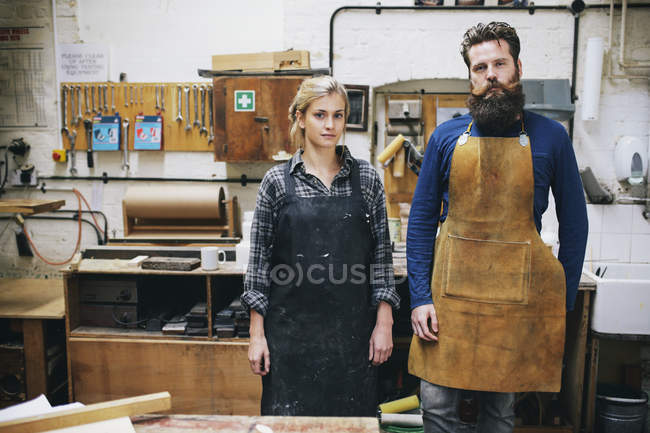 Portrait of craftsman and woman in organ workshop — Stock Photo