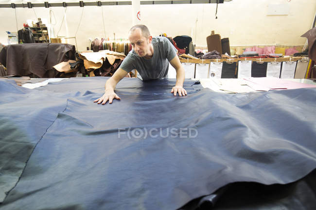 Man working in leather jacket manufacturers — Stock Photo