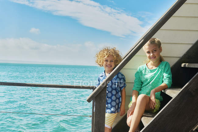 Мальчик и девочка на лестнице плавучего дома, Фалбаай, Южная Африка — стоковое фото