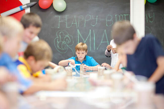 Boys making objects at children's birthday party — Stock Photo