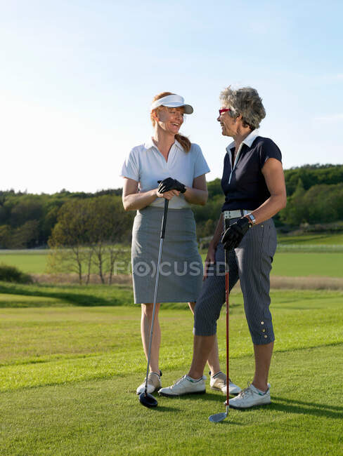 Two women at tee — Stock Photo