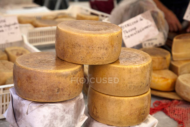 Cheese wheels for sale — Stock Photo