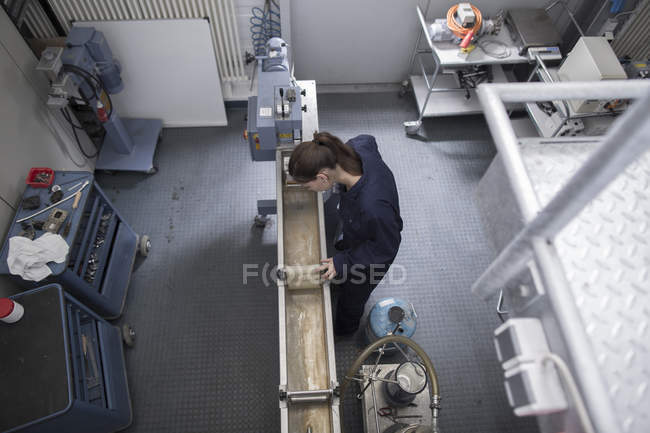 Vista ad alto angolo di ingegnere donna che controlla macchinari di produzione — Foto stock