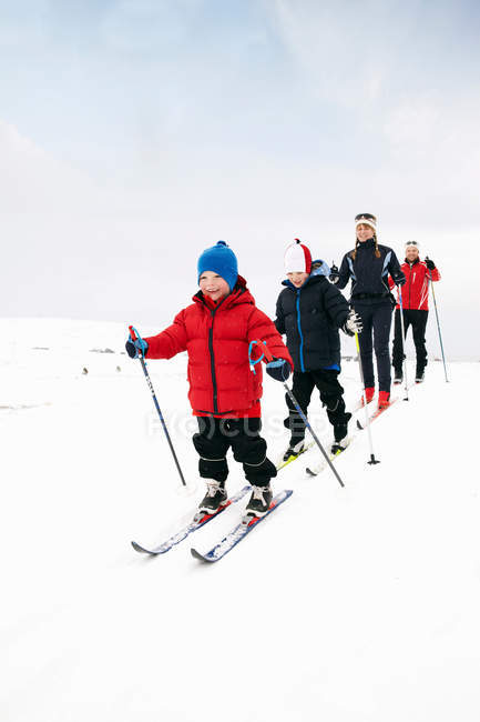 Family cross country skiing in snow at winter — Stock Photo
