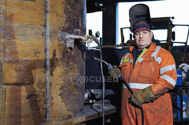 Portrait of mature welder in quarry workshop — Stock Photo