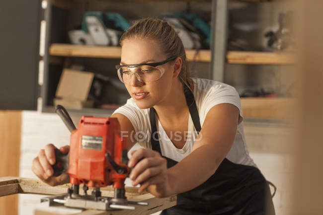 Carpinteiro trabalhando com ferramentas elétricas — Fotografia de Stock