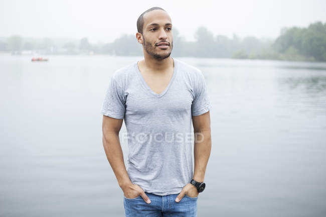 Portrait of young man by lake — Stock Photo