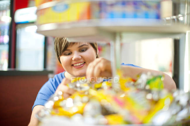Young woman selecting confectionery in cafe — Stock Photo