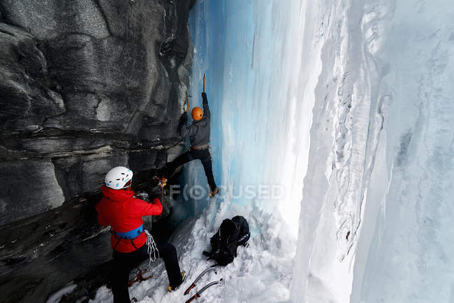 Coppia in grotta arrampicata su ghiaccio, Saas Fee, Svizzera — Foto stock