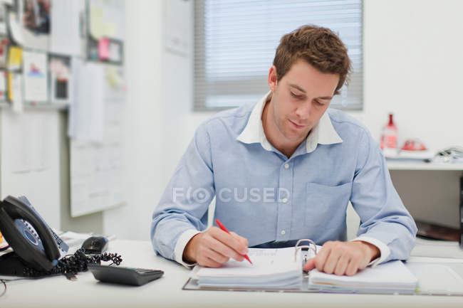 Businessman working at desk — Stock Photo
