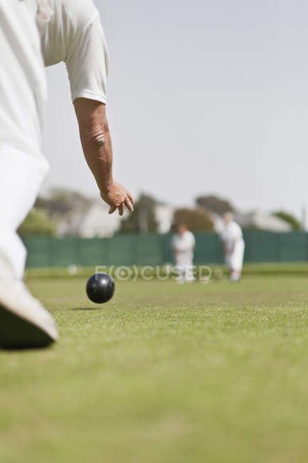 Old man playing lawn bowling, cropped — Stock Photo