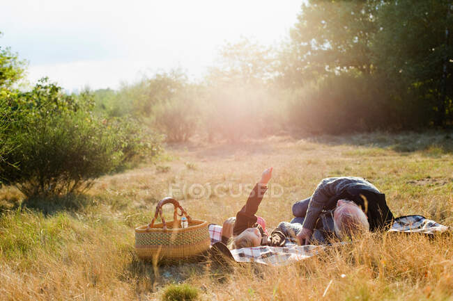 Grandfather and granddaughter at picnic — Stock Photo