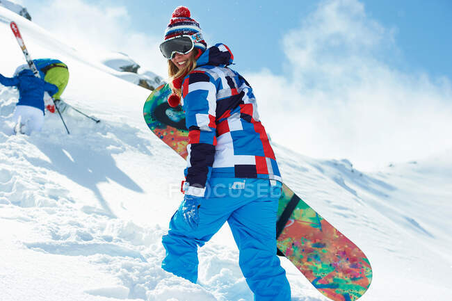 Female snowboarder in snow — Stock Photo