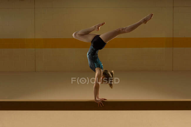 Teenage gymnast on beam — Stock Photo