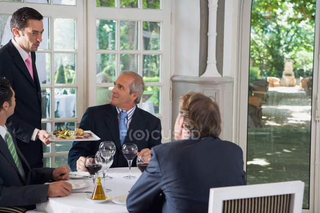 Three businessmen having lunch — Stock Photo