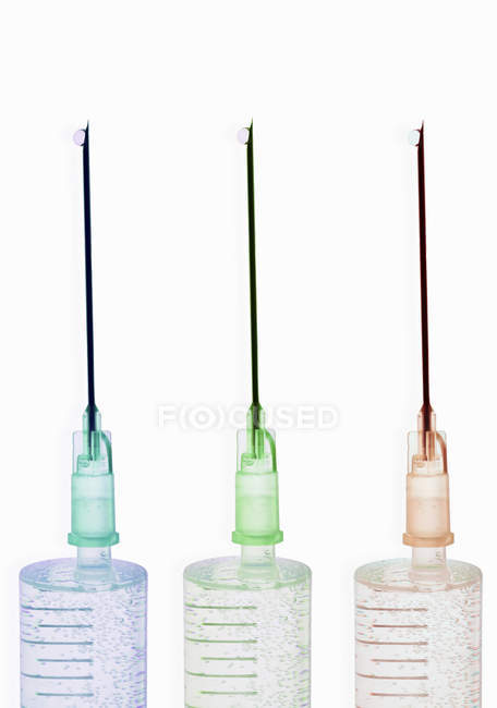 Close up shot of colored syringes isolated on white — Stock Photo
