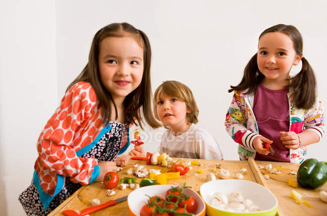 Children cooking together in kitchen — Stock Photo