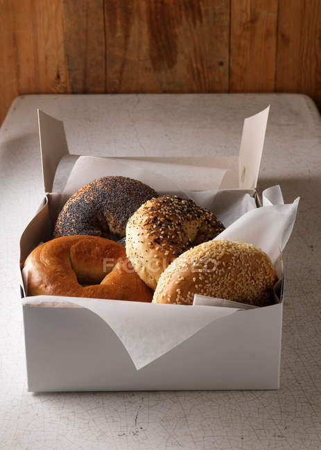 Box of various bagels with seeds and poppy — Stock Photo