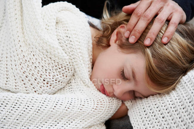 Girl sleeping under blanket — Stock Photo