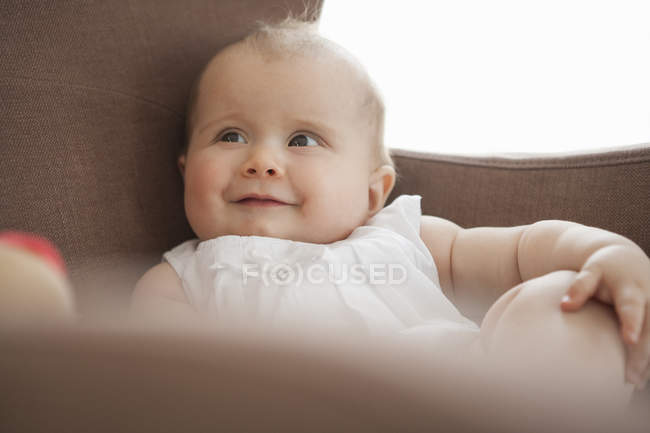 Baby sitting in armchair — Stock Photo