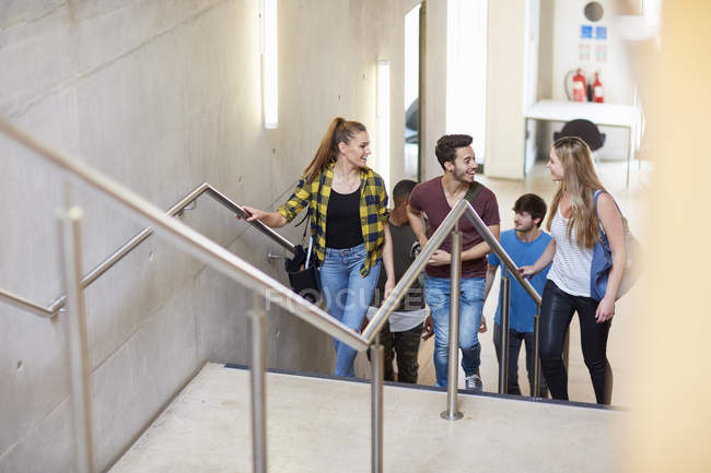 Group of students moving up stairway at higher education college — Stock Photo