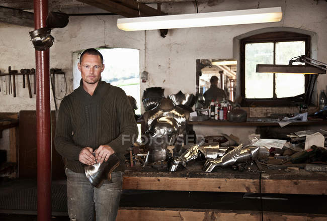 Blacksmith with armor in shop, selective focus — Stock Photo