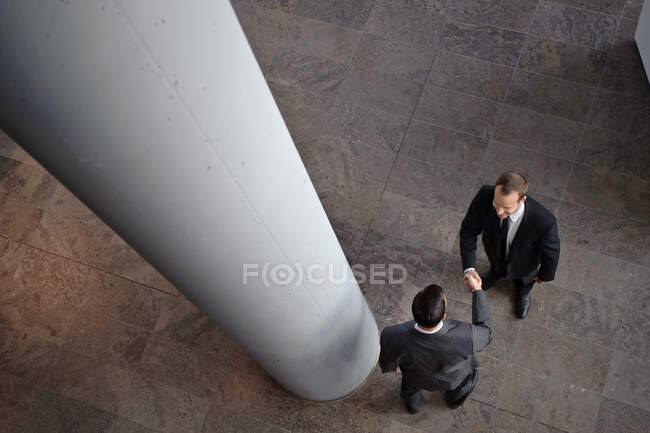 Two business men are shaking hands — Stock Photo