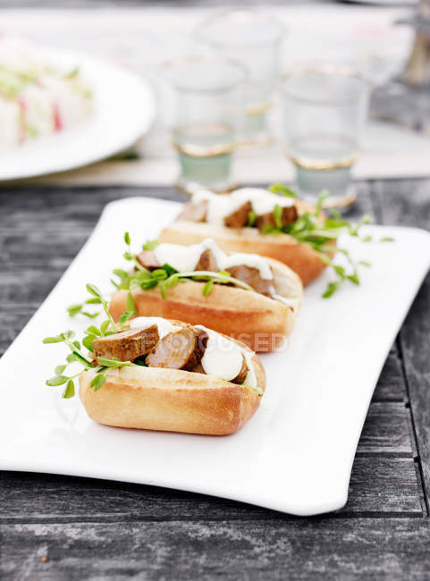 Plate of sandwiches with herbs — Stock Photo