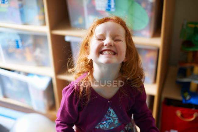 Girl making face in playroom — Stock Photo