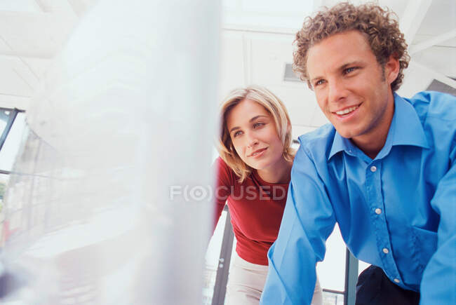 Business people using computer together — Stock Photo