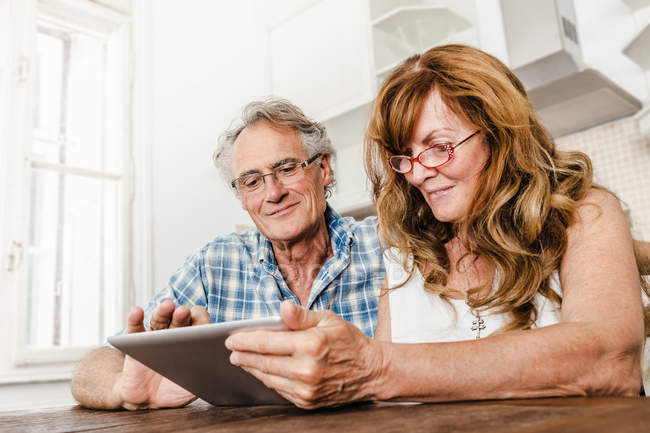 Couple plus âgé utilisant un ordinateur tablette — Photo de stock