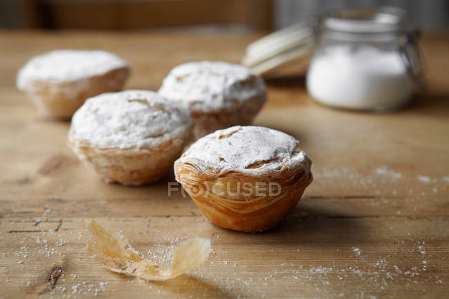 Baked puff pastries on wooden table — Stock Photo