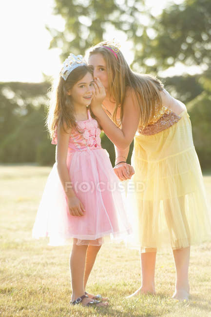 Sisters whispering outdoors, selective focus — Stock Photo