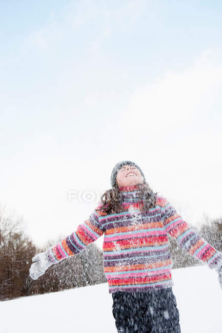 Girl standing in flurry of snow — Stock Photo