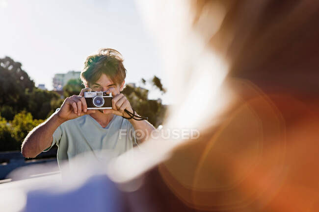 Young man taking pictures — Stock Photo