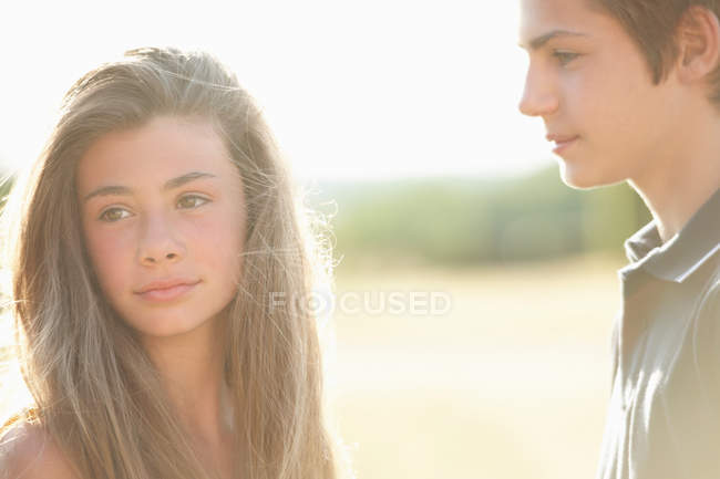 Teenage couple standing outdoors, selective focus — Stock Photo