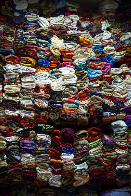Wall of stacked colorful fabric for sale — Stock Photo