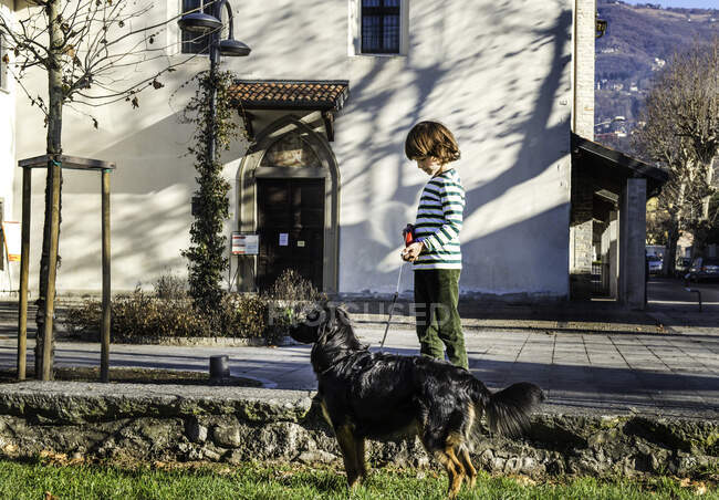 Boy playing with his best friend, his pet dog — Stock Photo
