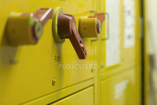 Close up of levers on yellow control panel — Stock Photo
