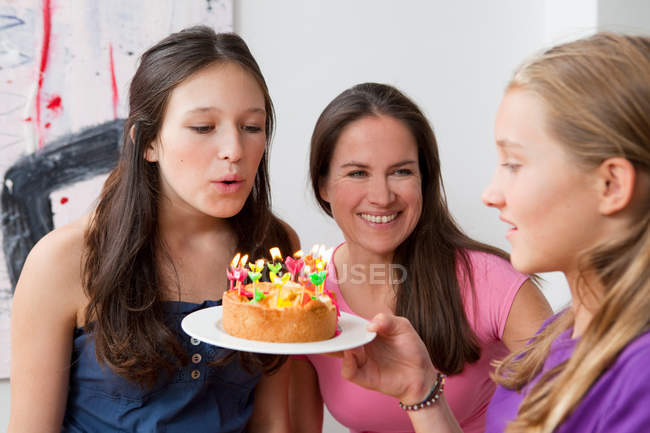 Girl blowing out birthday candles, selective focus — Stock Photo