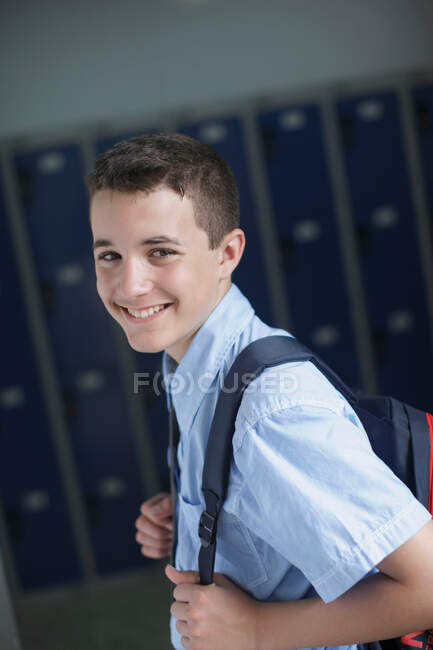 School boy holding backpack — Stock Photo
