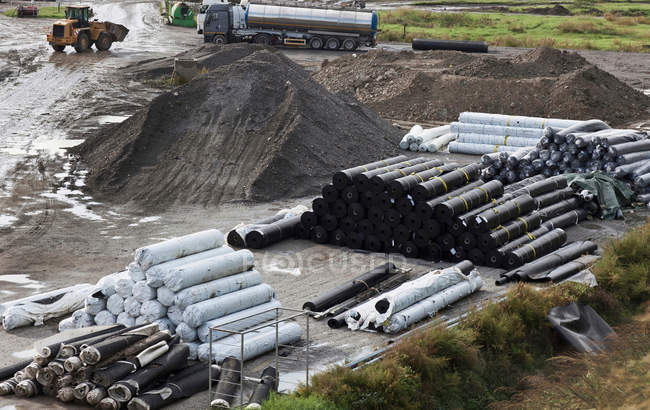 Material in garbage collection center with parked bulldozer — Stock Photo