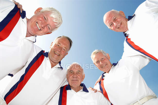 Male bowlers leaning over camera — Stock Photo