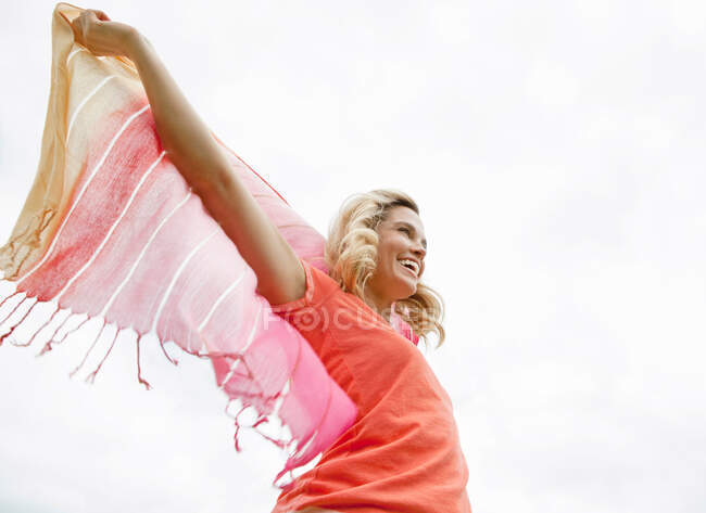 Woman playing with shawl outdoors — Stock Photo